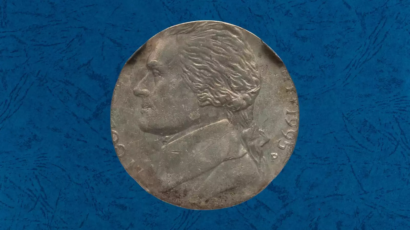 1995 nickel struck on wrong cent or dime planchet — copper-colored coin smaller than a standard nickel