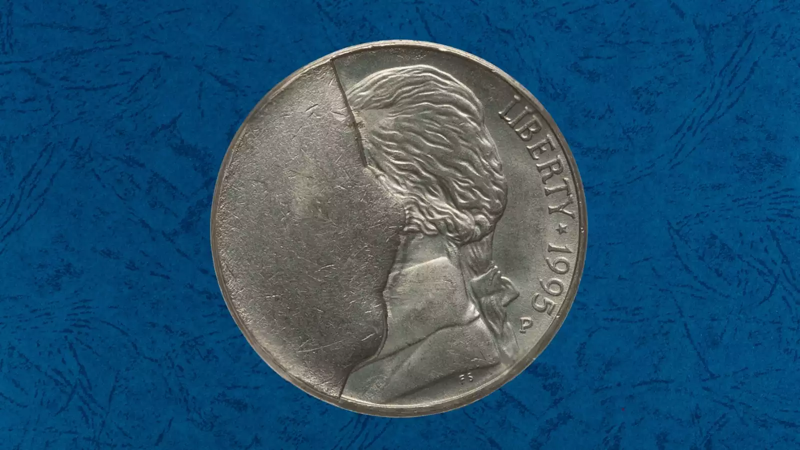 1995 Jefferson nickel major die break cud error showing raised lump of metal near coin rim